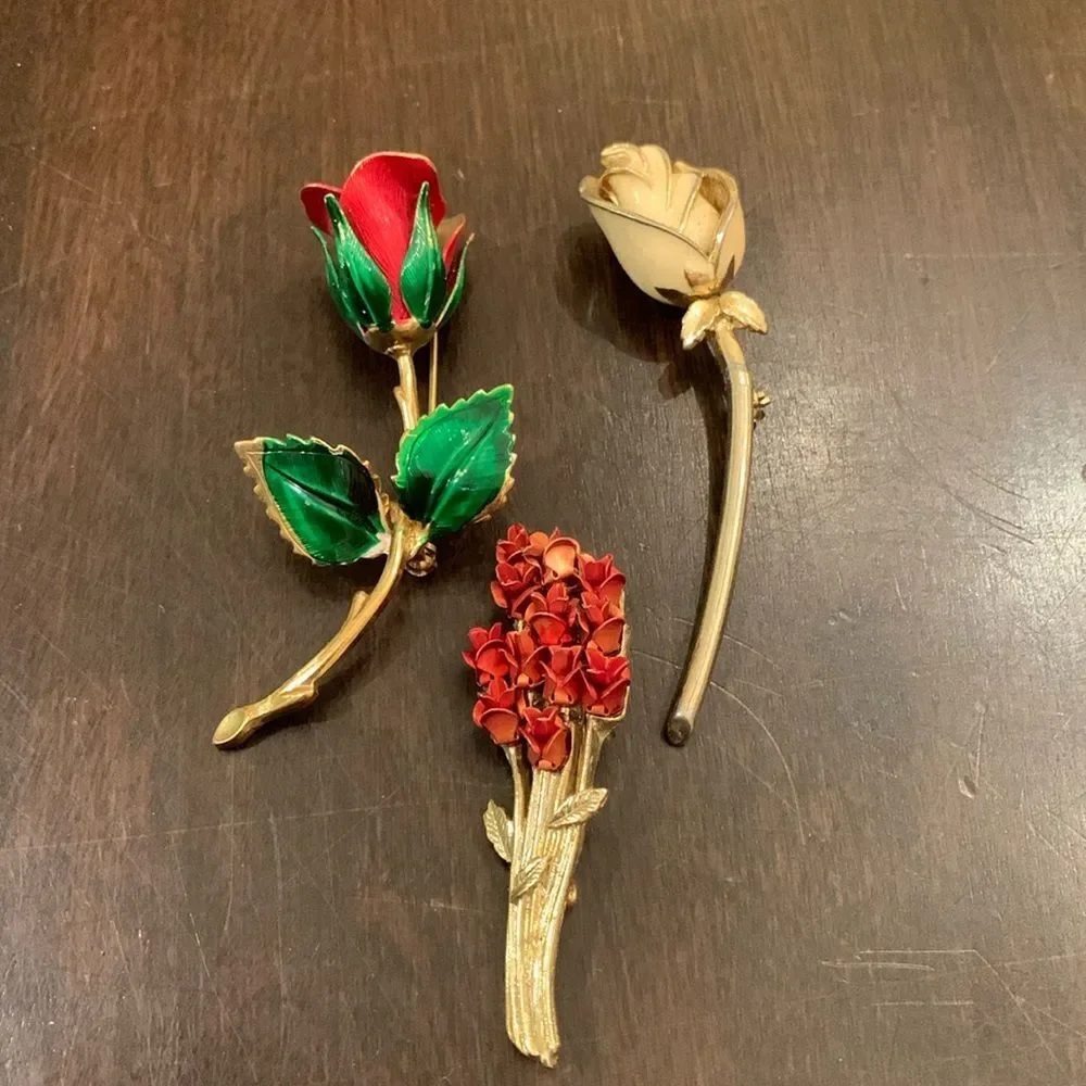 Three vintage rose brooches